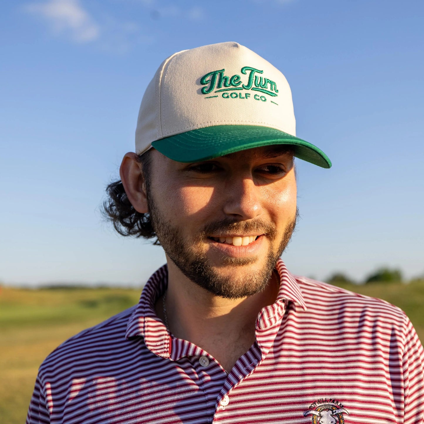 man in green two tone golf hat